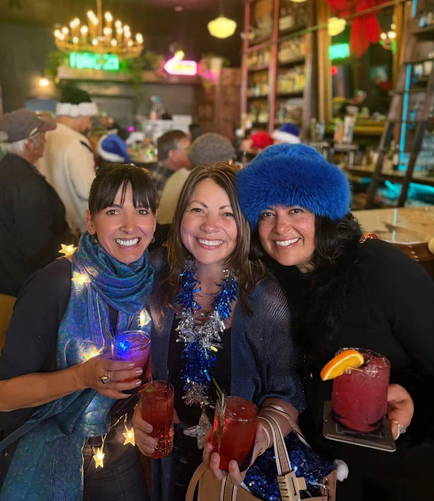 Three guests toasting with cocktails at Borracho's