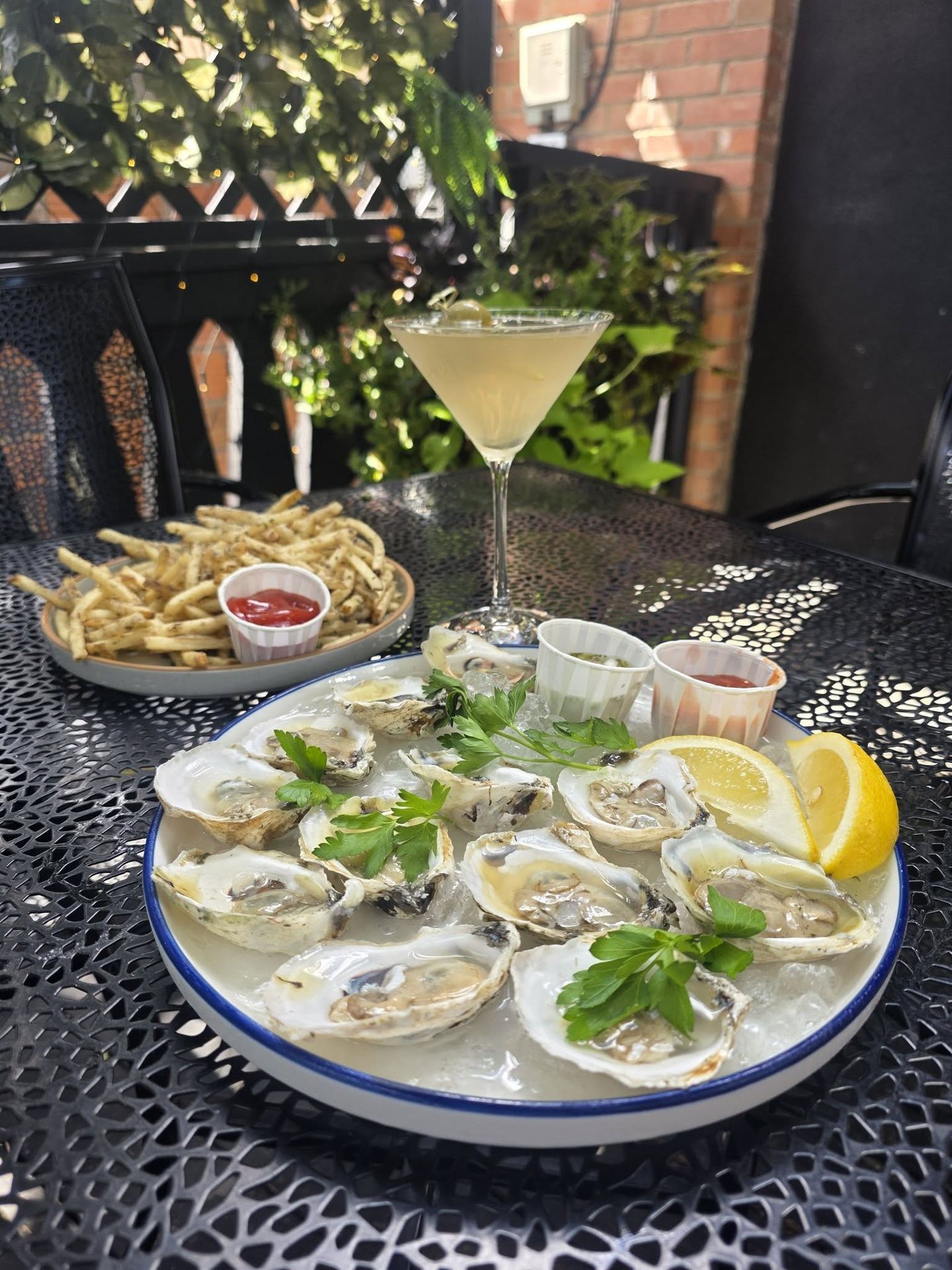 Oysters on the patio with fries and a cocktail at Borracho's