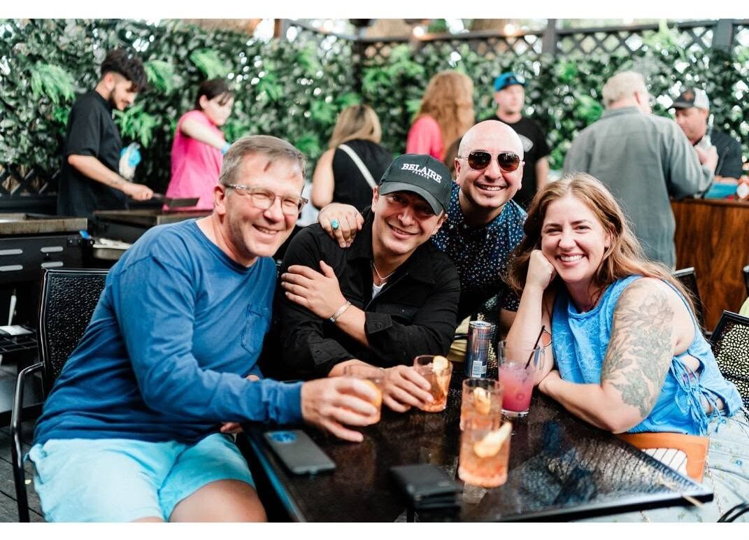 Friends gathered around a table on Borracho's patio
